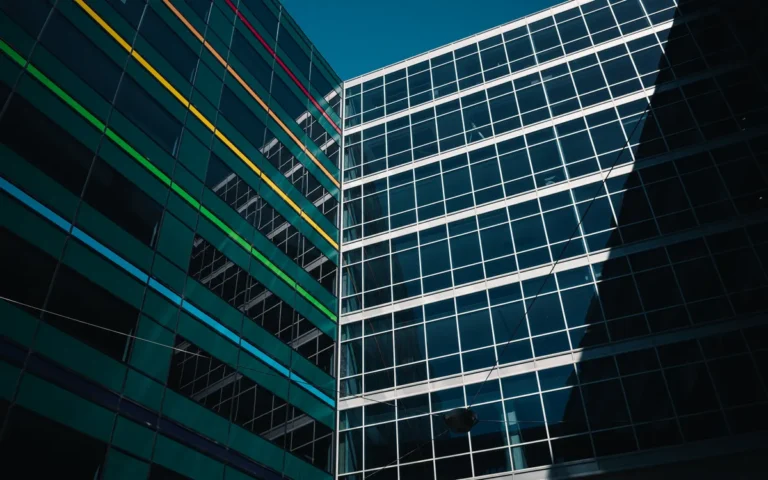 Architectural view of modern buildings with colorful stripes against a clear blue sky