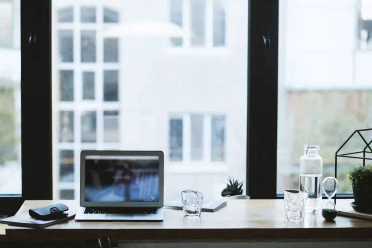 Civil servant fraud trial: ‘I wasn’t thinking straight,’ defendant tells court Sleek office desk setup featuring a laptop, glass of water, and open window view